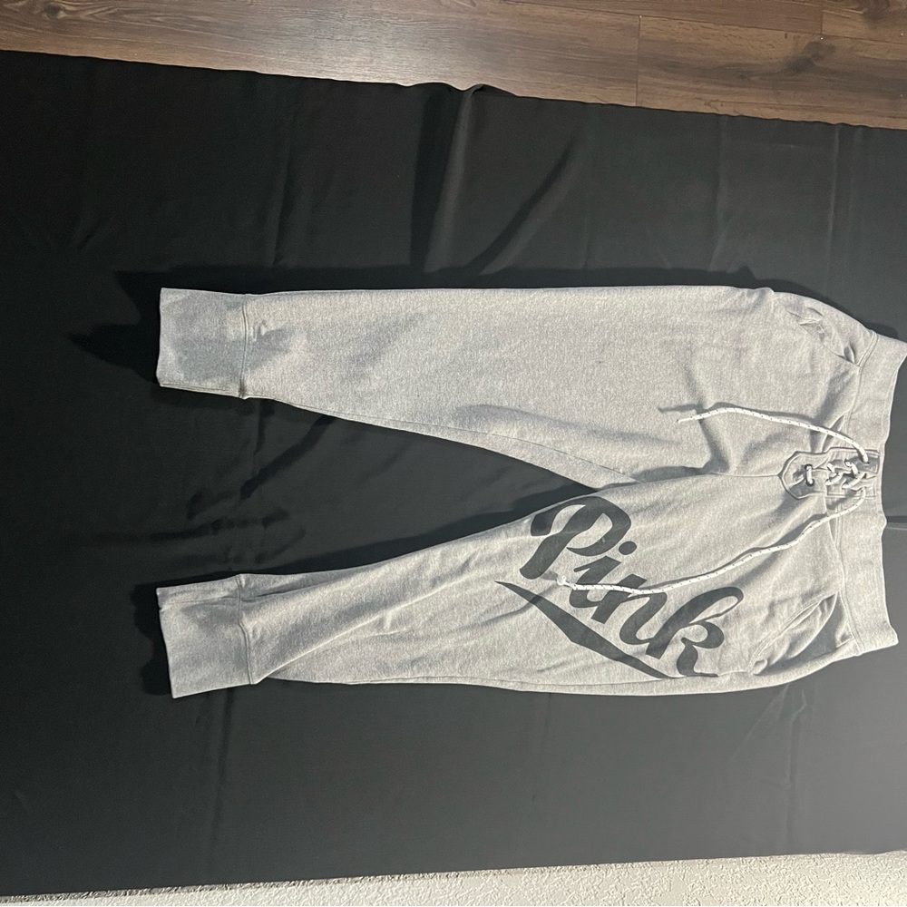 Pink Victoria’s Secret gray sweat pants with lace up front.
